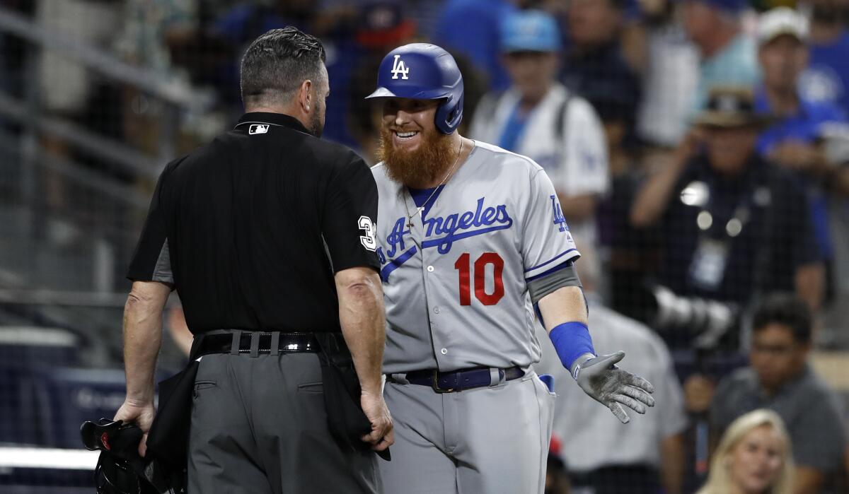 Dodgers third baseman Justin Turner argues with home plate umpire Rob Drake after striking out to end Monday's game against the Padres.