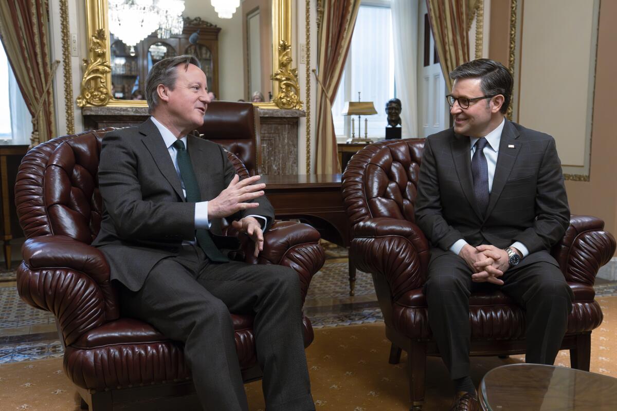 Britain's Foreign Secretary David Cameron, left, meets with Speaker of the House Mike Johnson, R-La.