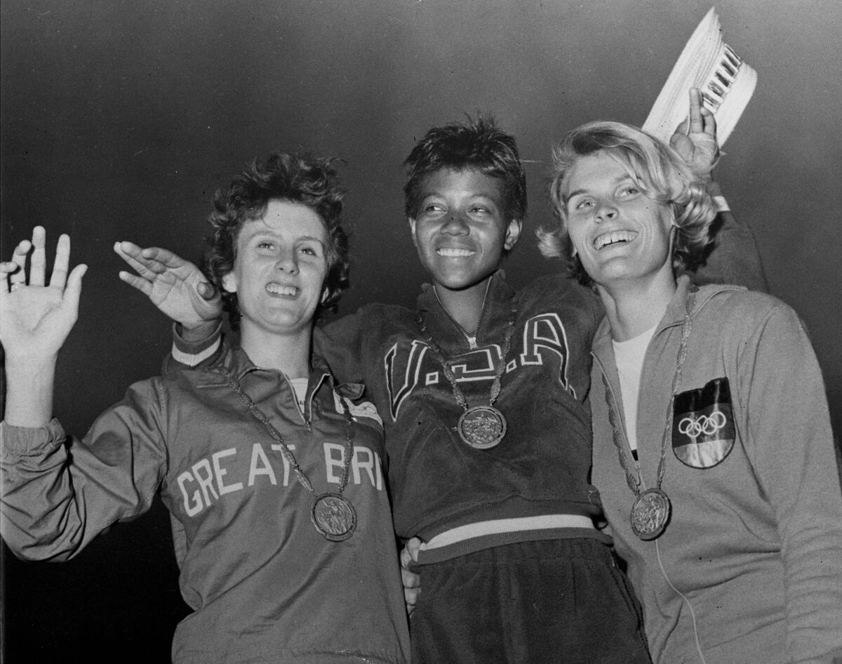 FILE - In this Sept. 5, 1960, file photo, the medalists in the women's 200-meter event, from left, bronze medalist Dorothy Hyman, of Great Britain; gold medalist Wilma Rudolph, of the United States, and silver medalist Jutta Heine, of Germany, pose with their medals at the Olympic stadium in Rome, Italy. The 1960 Rome Summer Olympics set the standard for every Olympiad to follow. These Games were the first televised in the United States, even if film of events had to be flown from Rome to New York where Jim McKay did the voice-overs the next day. (AP Photo/File)