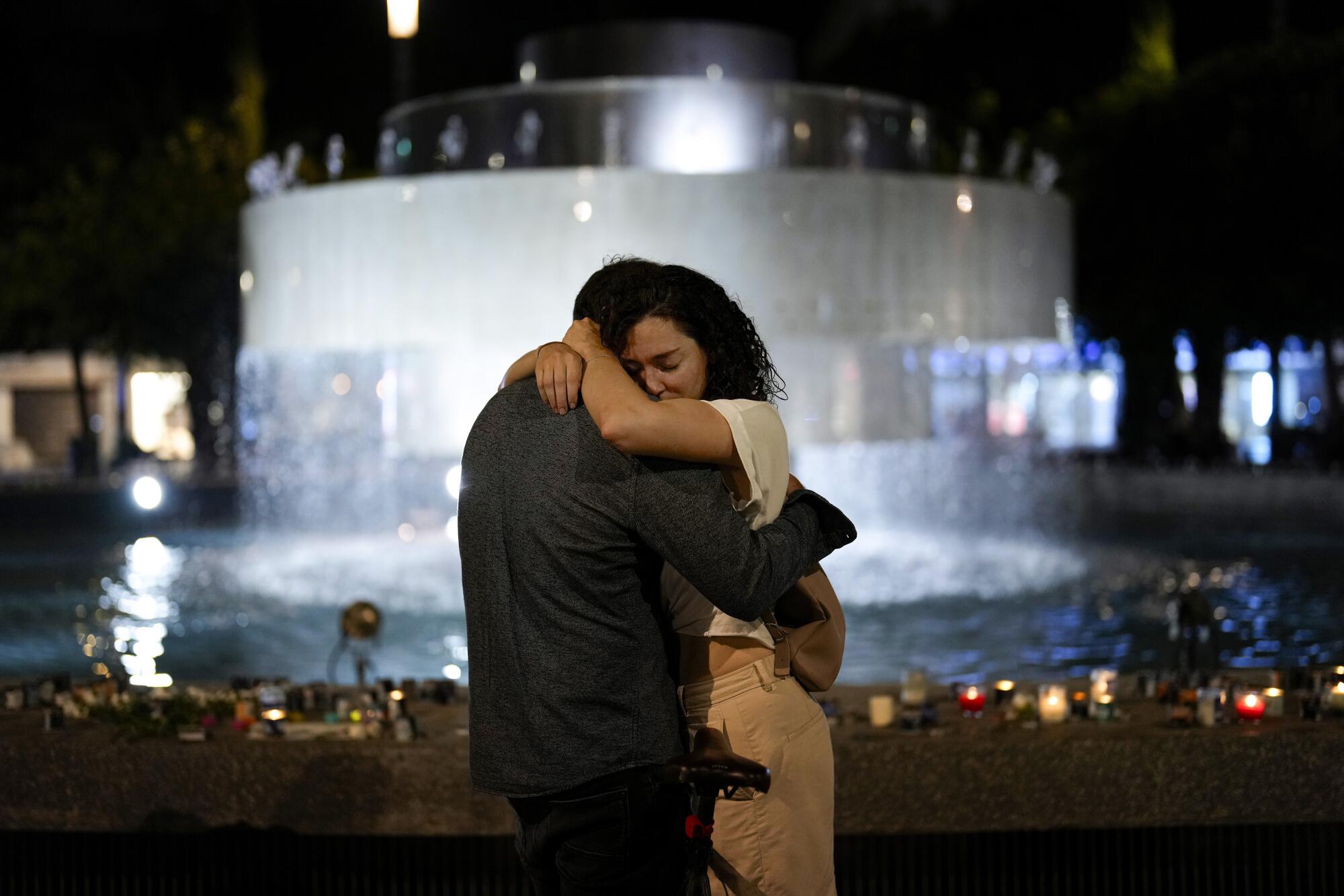 Couple embracing at a vigil for Israelis killed in Hamas attack