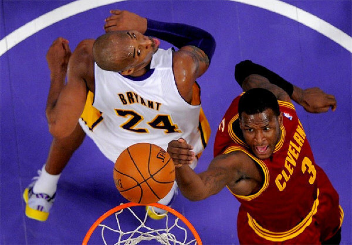 Kobe Bryant forces Cavaliers guard Dion Waiters into an off-balance shot at the rim.