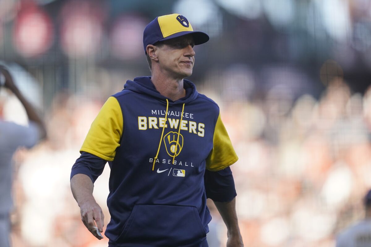 Christian Yelich of the Milwaukee Brewers walks back to the dugout