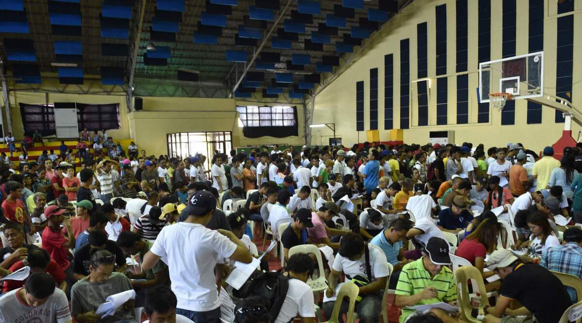 Drug users and dealers filling out forms on July 18 after voluntarily surrendering to local authorities in Tanauan town, Batangas province, south of Manila.