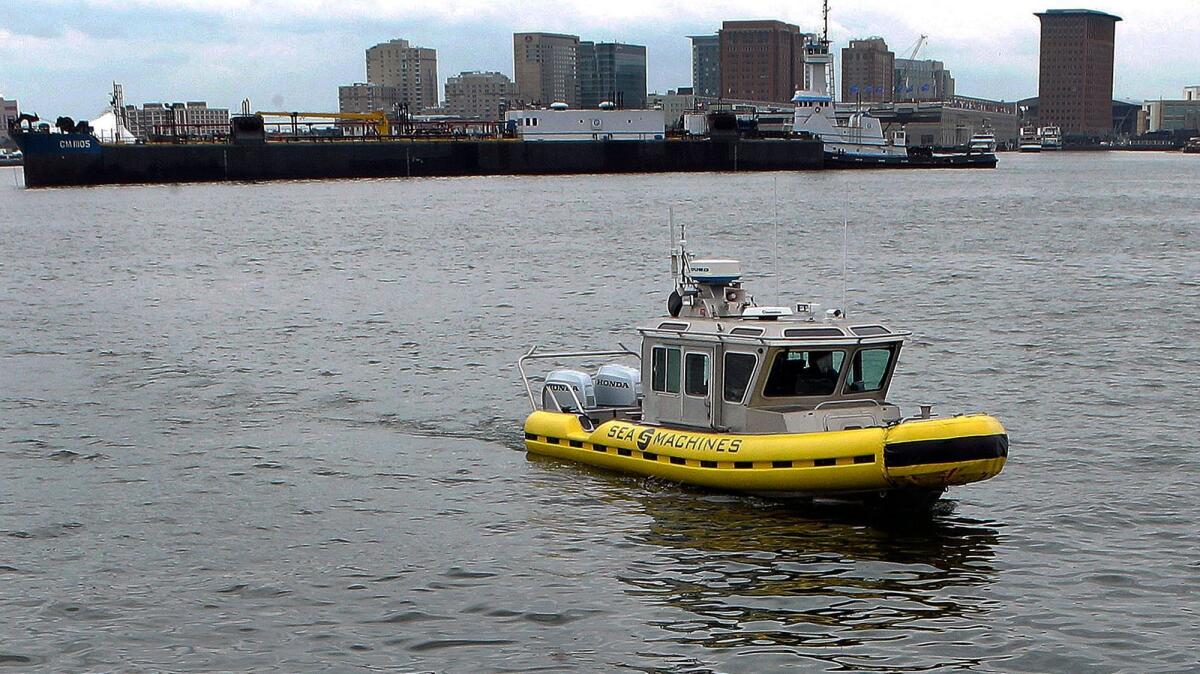 A boat capable of autonomous navigation makes its way around Boston Harbor.