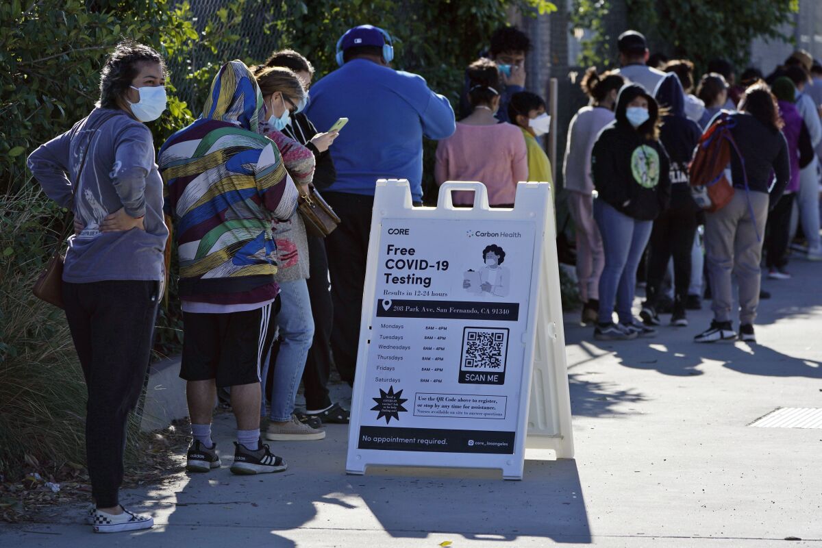 People line up at a COVID-19 testing center Wednesday, Jan. 5, 2022, in San Fernando, Calif. (AP Photo/Marcio Jose Sanchez)