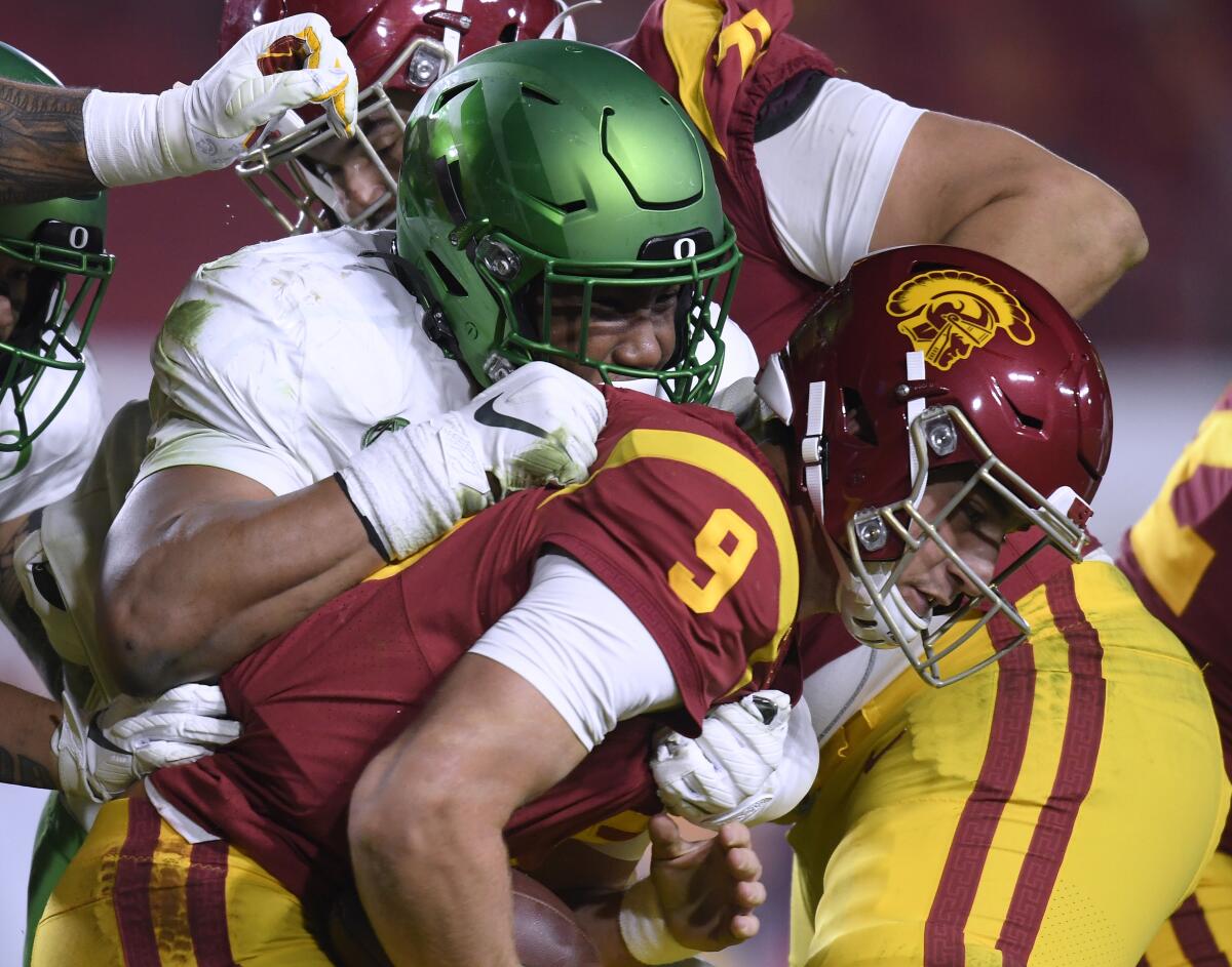 USC's Kedon Slovis is sacked by Oregon's Brandon Dorlus during the Pac-12 title game Dec. 18, 2020, in Los Angeles.