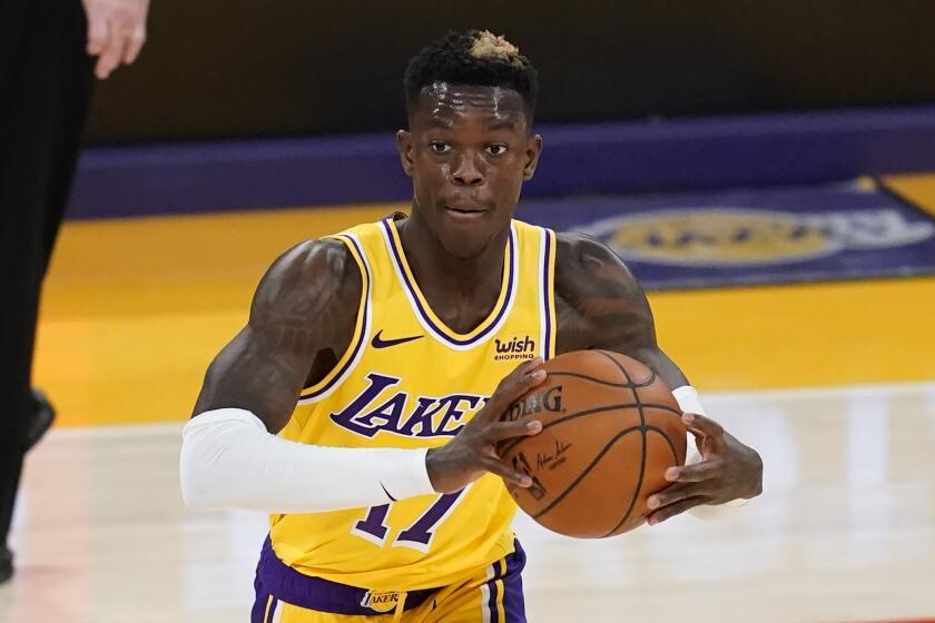 Los Angeles Lakers guard Dennis Schroder (17) passes the ball during the second quarter.