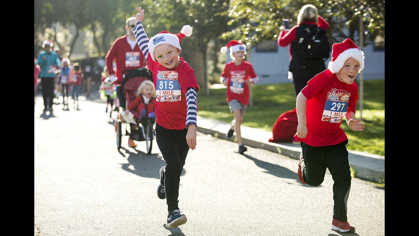 Kids run to the finish during the 4th Annual â€œRun for a Clausâ€ 1-Mile Kidsâ€™ Run at UC Irvine on Saturday, December 2.