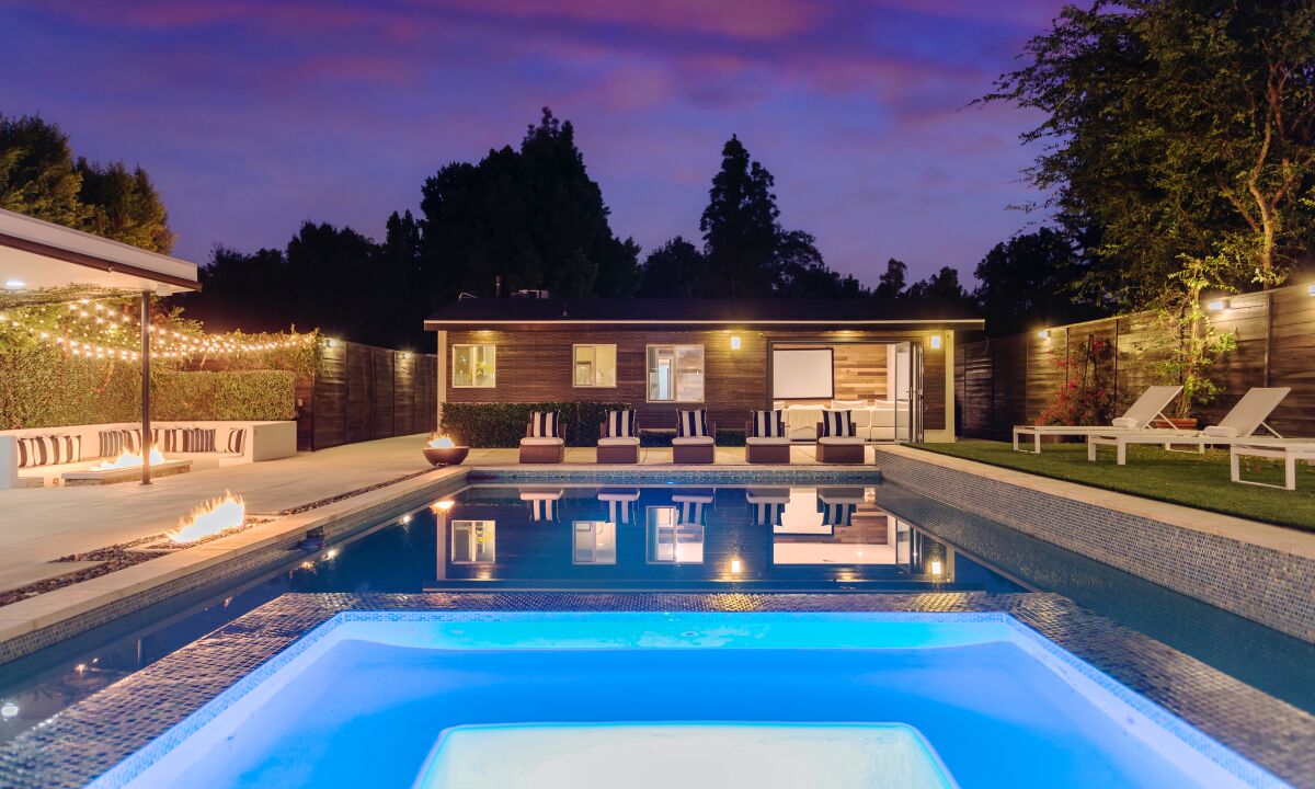 The small compound holds a main house, guesthouse and decked-out yard with fountains, fire pits, a sunken conversation pit and swimming pool.
