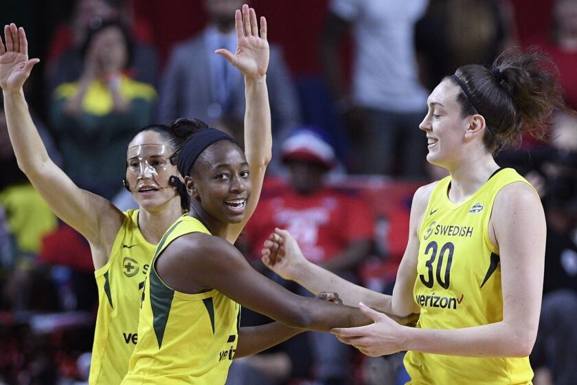 Seattle Storm guard Sue Bird, back left, Jewell Loyd, center, and Breanna Stewart (30) react during the first half of Game 3 of the WNBA basketball finals against the Washington Mystics, Wednesday, Sept. 12, 2018, in Fairfax, Va. (AP Photo/Nick Wass)