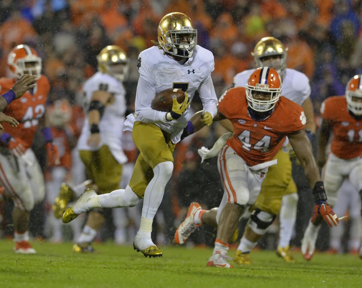 Notre Dame's Will Fuller slices through the field while pressured by Clemson's B.J. Goodson during the second half.