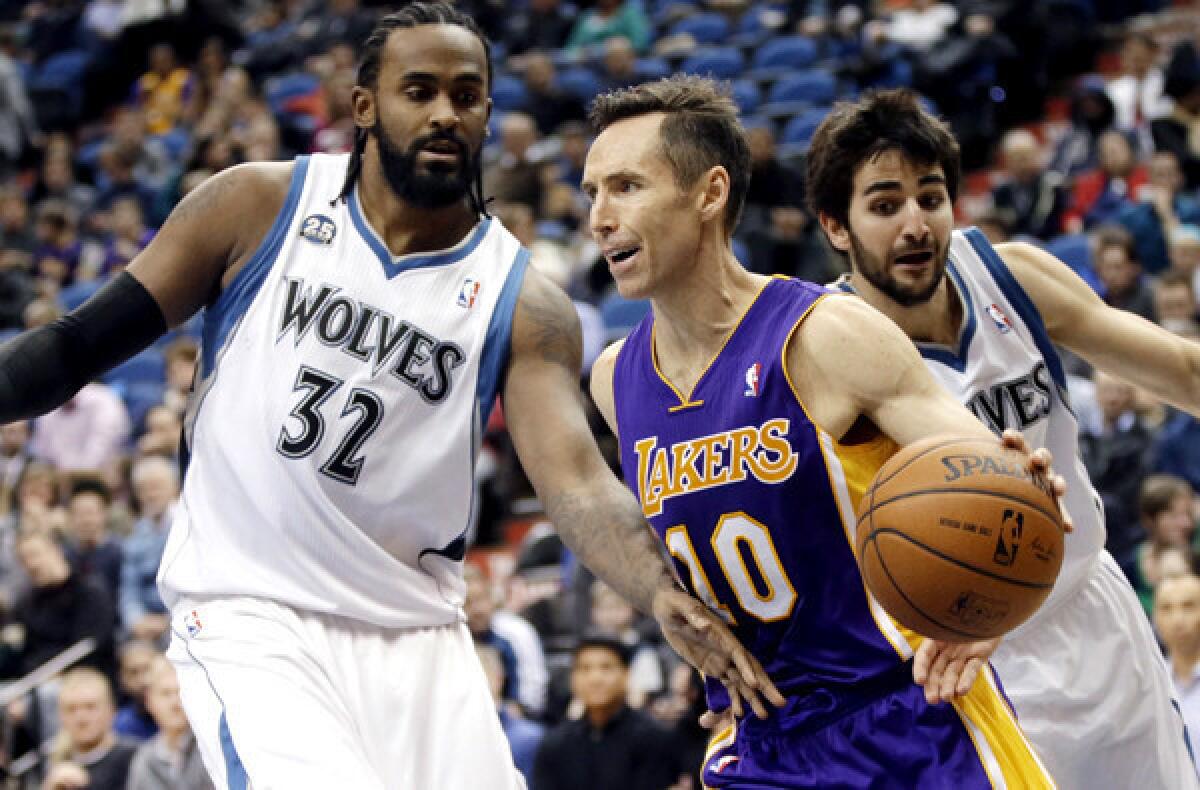 Lakers point guard Steve Nash (10) tries to drive past the double-team defense of Timberwolves center Ronny Turiaf (32) and point guard Ricky Rubio during a game Tuesday in Minneapolis.