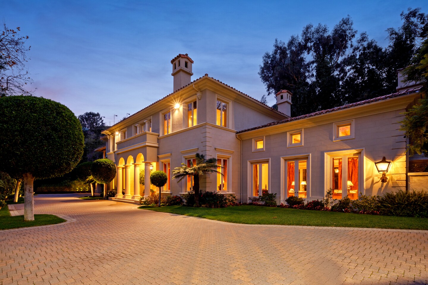The Bel-Air estate of late automobile titan Lee Iacocca sold for $19.5 million after listing for sale in January at about $26 million. The Iacocca family were the original owners of the property, which sits on more than an acre with a swimming pool, gardens and a tennis court. Among features of the Italianate-vibe house are five fireplaces, a foyer with arched ceilings and a grand living room. French doors open onto a stone pavilion. The estate on Chalon Road entered escrow amid the pandemic in March and sold a month later to Lilly Halichi and Dara Mir, who appear on"Shahs of Sunset."