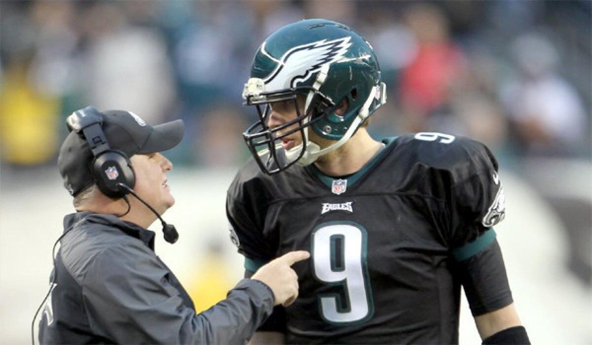 Philadelphia Coach Chip Kelly talks with his starting quarterback Nick Foles during the Eagles' 24-21 win over the Arizona Cardinals on Sunday.