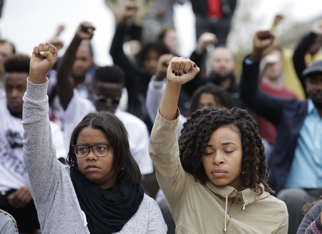 Supporters raise their fists in solidarity during a rally at Traditions Plaza on the University of Missouri campus in Columbia, Mo., calling for the resignation of the University of Missouri System President Tim Wolfe. The group organized the rally to draw attention to race relations on campus.