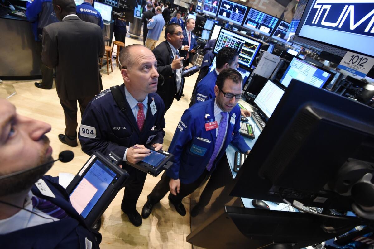 Investors reacted calmly Wednesday to a report showing a sharp contraction in economic activity in the first quarter. Above, traders on the New York Stock Exchange earlier this year.