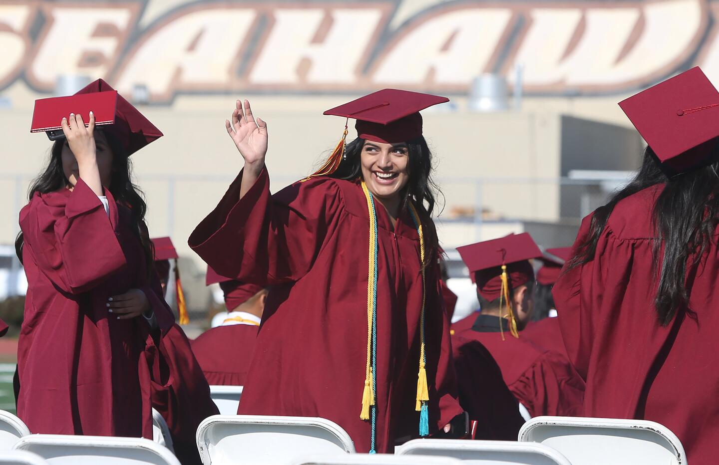 Nailea Hernandez, who graduated with honors, waves to family during the 2019 Ocean View High School commencement ceremony on Wednesday.