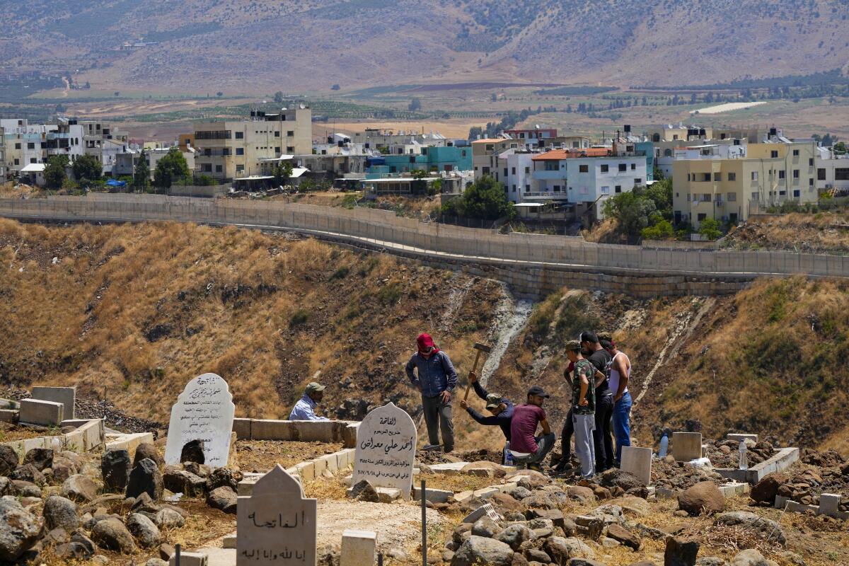Residents digging a grave at a cemetery in Lebanon