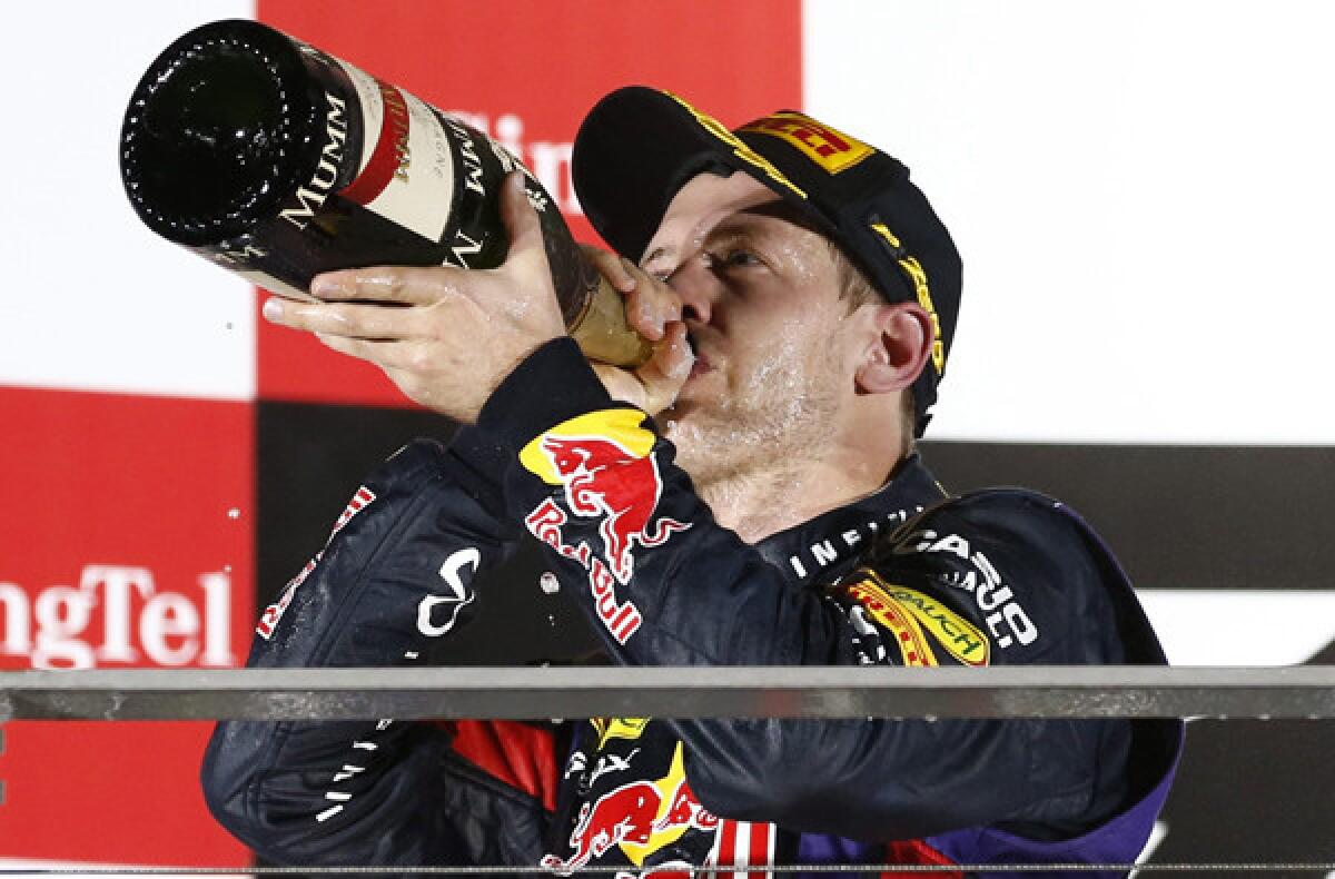 Formula One driver Sebastian Vettel celebrates after winning the Singapore Grand Prix on Sunday night.