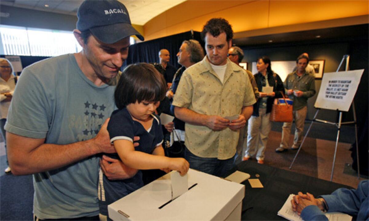 FAMILY MATTERS: Writer Greg Fields lets 3-year-old son Caelan cast his ballot at the Writers Guild of America Theater.