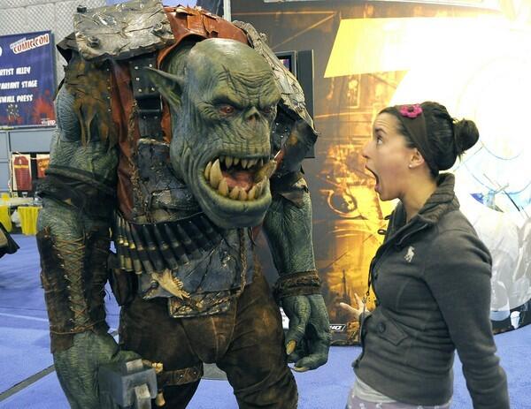 A Convention goer stands next to Ork fro