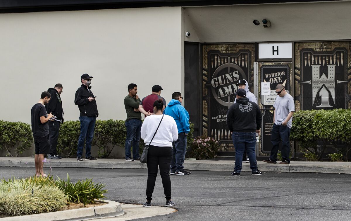 Customers wait in line to buy guns at Riverside's Warrior One Guns and Ammo