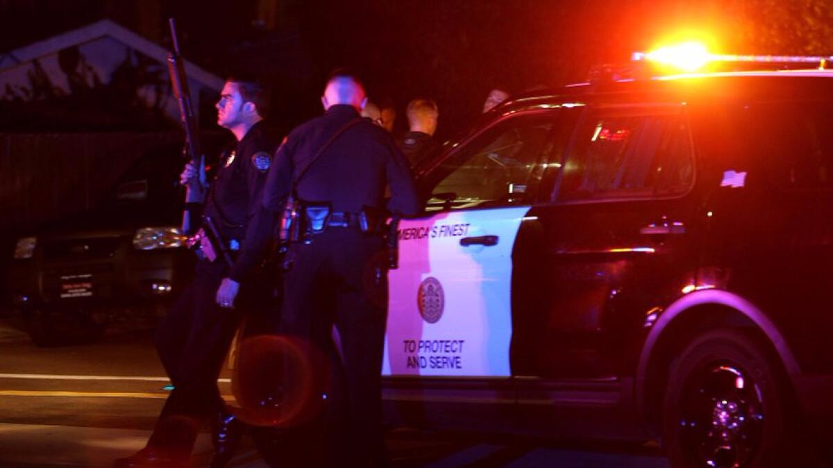 San Diego police and other law enforcement personnel gather near the scene of the shooting Thursday night.