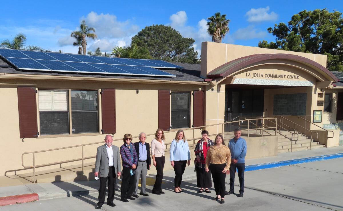 Officials and donors show the La Jolla Community Center's new roof and solar panels.