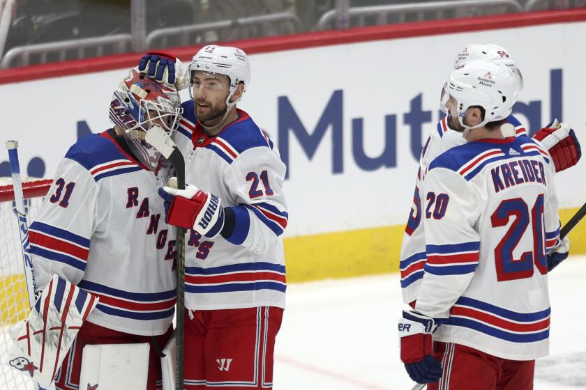 New York Rangers goaltender Igor Shesterkin (31) is embraced by teammate Barclay Goodrow (21) after defeating the Washington Capitals in Game 3 of an NHL hockey Stanley Cup first-round playoff series, Friday, April 26, 2024, in Washington. (AP Photo/Tom Brenner)