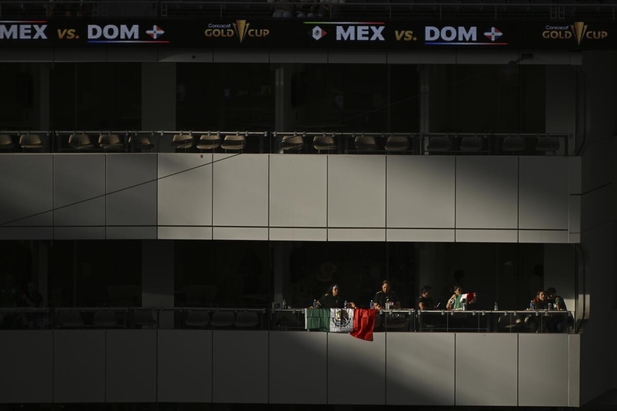 Fans enter a stadium.