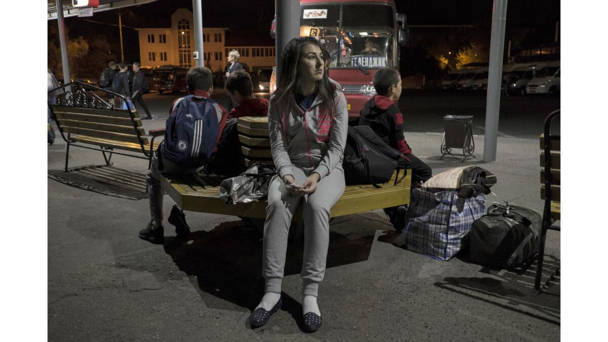 Indira Karakayeva waits at a bus station in Stavropol for her trip to Dagestan to visit her parents.