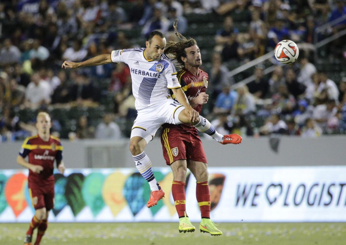 Landon Donovan and Kyle Beckerman jump for a header during a match on July 12.