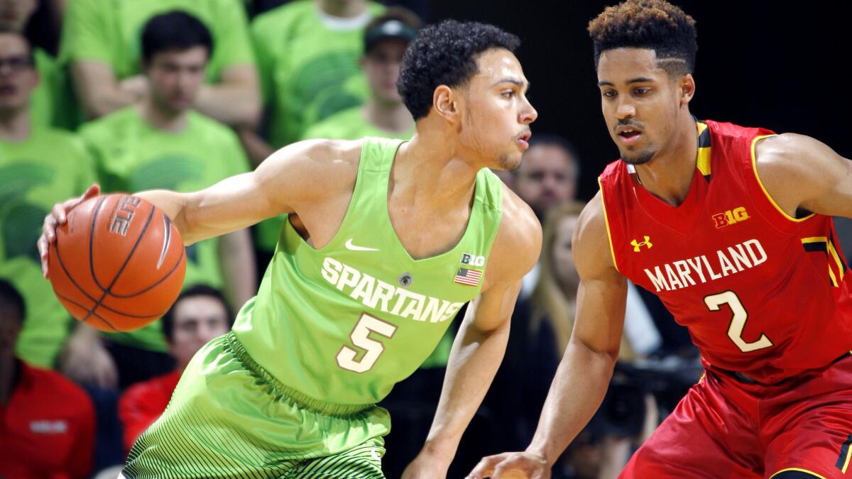 Michigan State's Bryn Forbes (5) drives against Maryland's Melo Trimble (2) during the first half of their game Saturday.