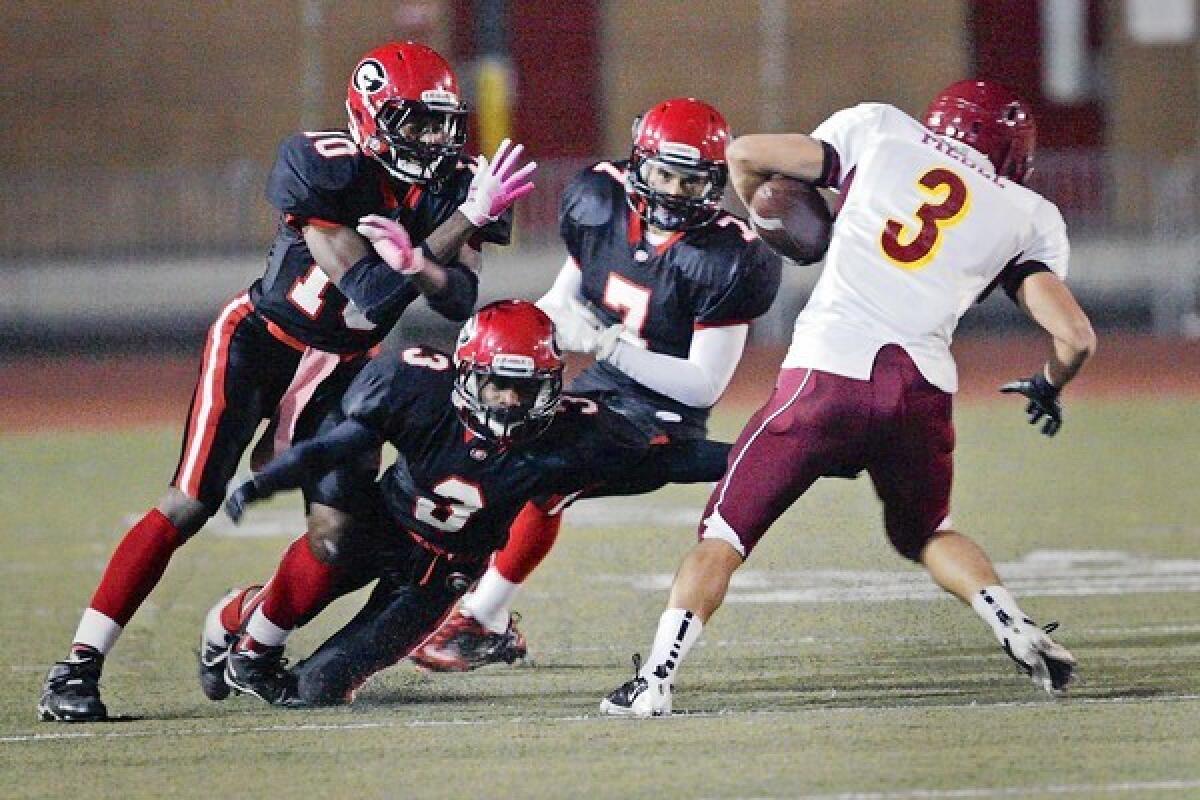 Glendale's Michael Davis, from left, Tony Collins and Junior Arevalo attempt to tackle Arcadia's Jake Medel during a Pacific League game at on Friday.