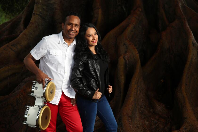 GLENDORA CALIF. APRIL, 6, 2020: Percussionist (timbalero) Clodomiro Montes and his wife Karina Zurita are photographed at Victory Park in Glendora Calif. Together they have a band named Colombian Latin Soul. Due to the Coronavirus Pandemic, their gigs have all been canceled. (Dania Maxwell/Los Angeles Times)