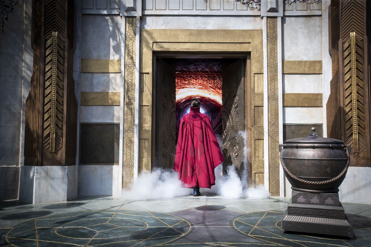 Doctor Strange faces a doorway with smoke coming out of it.