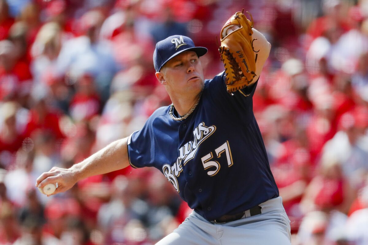 FILE - In this Sept. 26, 2019, file photo, Milwaukee Brewers starting pitcher Chase Anderson throws in the first inning of a baseball game against the Cincinnati Reds in Cincinnati. The Brewers cut $15 million in payroll for next season, trading right-hander Anderson to the Toronto Blue Jays on Monday, Nov. 4, 2019, for prospect Chad Spanberger and declining a $7.5 million option on first baseman Eric Thames. (AP Photo/John Minchillo, File)