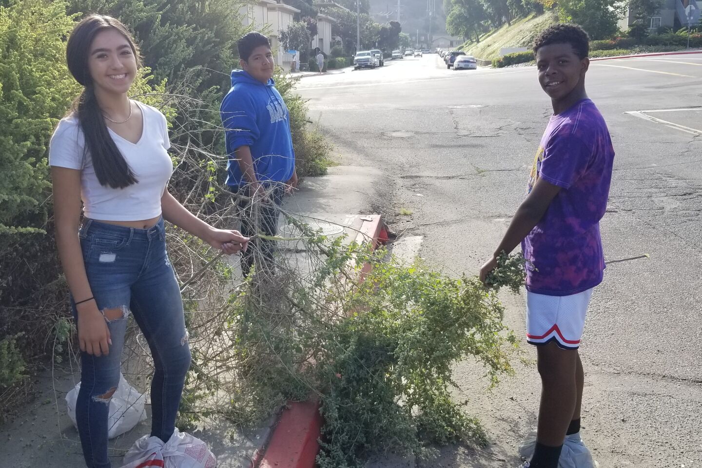 Gianna, Jemel and Guillermo pose proudly with their conquest of salt bush.