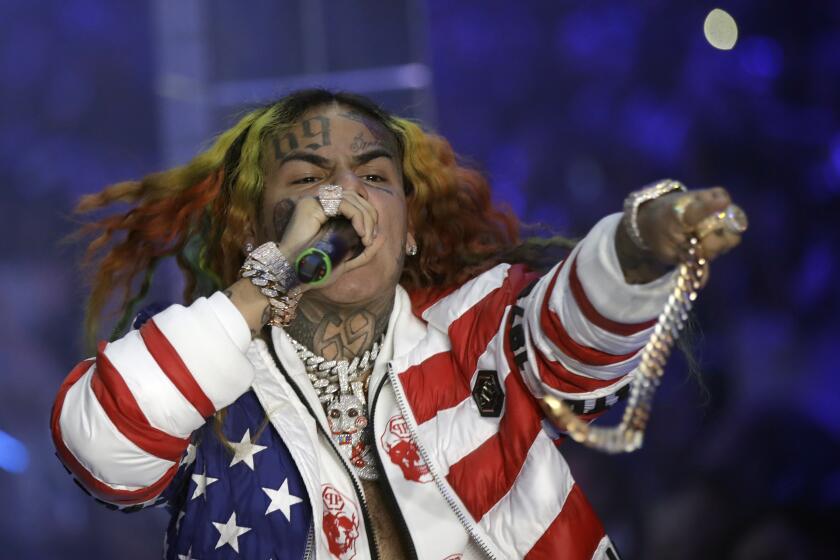 FILE- In this Sept. 21, 2018, file photo rapper Daniel Hernandez, known as Tekashi 6ix9ine, performs during the Philipp Plein women's 2019 Spring-Summer collection, Milan, Italy. Hernandez is set to testify Tuesday, Sept. 17, 2019, as a prosecution witness at the federal trial of alleged members of a violent New York City gang. (AP Photo/Luca Bruno, File)