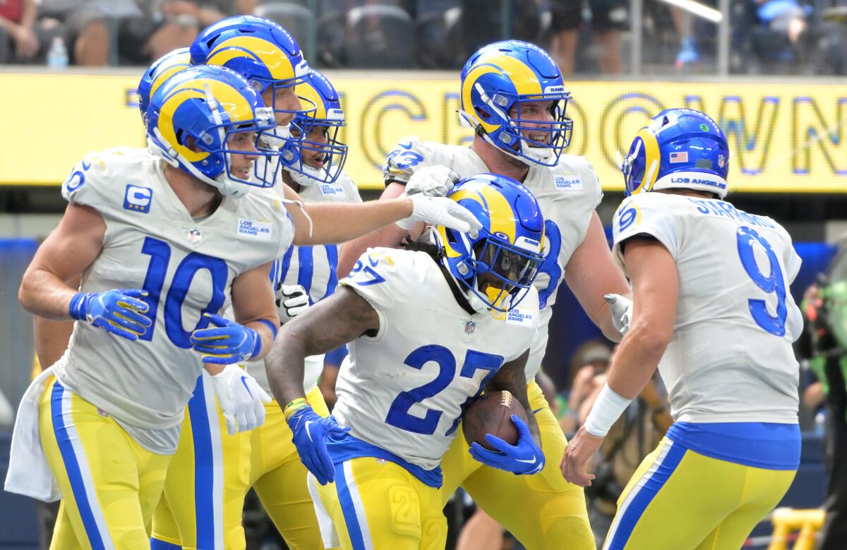 Rams running back Darrell Henderson celebrates with teammates after scoring a touchdown.