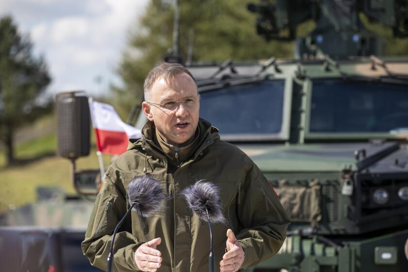 Poland's President Andrej Duda speaks during a joint media conference with Lithuania's President Gitanas Nauseda during the Lithuanian-Polish Brave Griffin 24/II military exercise near the Suwalki Gap close to the Polish border at the Dirmiskes village, Alytus district west of the capital Vilnius in Lithuania on Friday, April 26, 2024. The week-long military exercise which started April 22, is to test a defense scenario on the bilateral so-called “Orsha” plan to defend the Suwałki Gap, a corridor of almost 100 kilometers (62 miles) between the two NATO members Poland and Lithuania. (AP Photo/Mindaugas Kulbis)