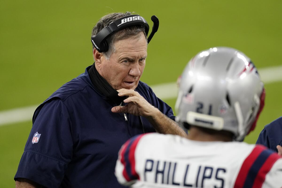 New England Patriots head coach Bill Belichick talks to Adrian Phillips.