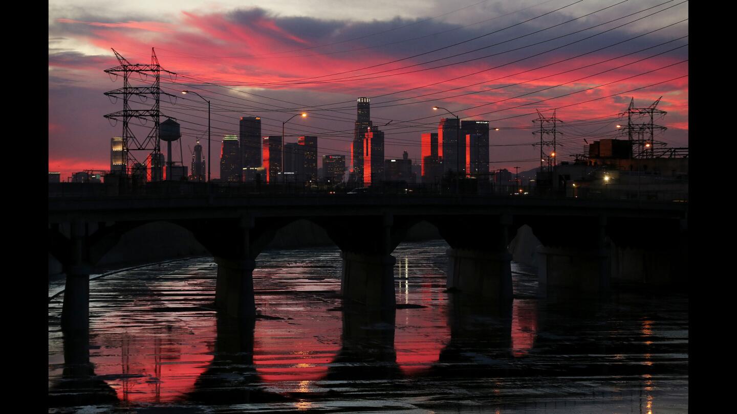 The Los Angeles River reflects late afternoon light as it flows beneath the Soto Street Bridge in Boyle Heights.