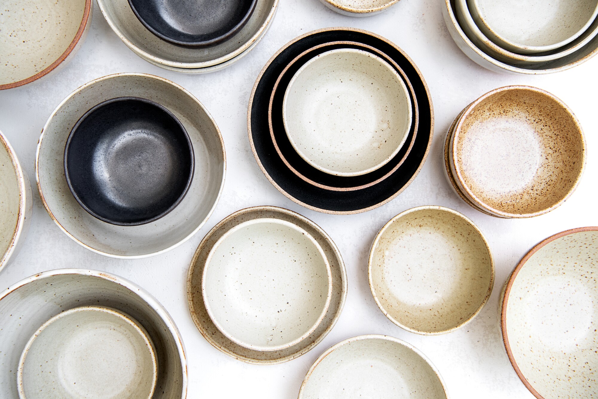 A series of bowls laid out on a table.