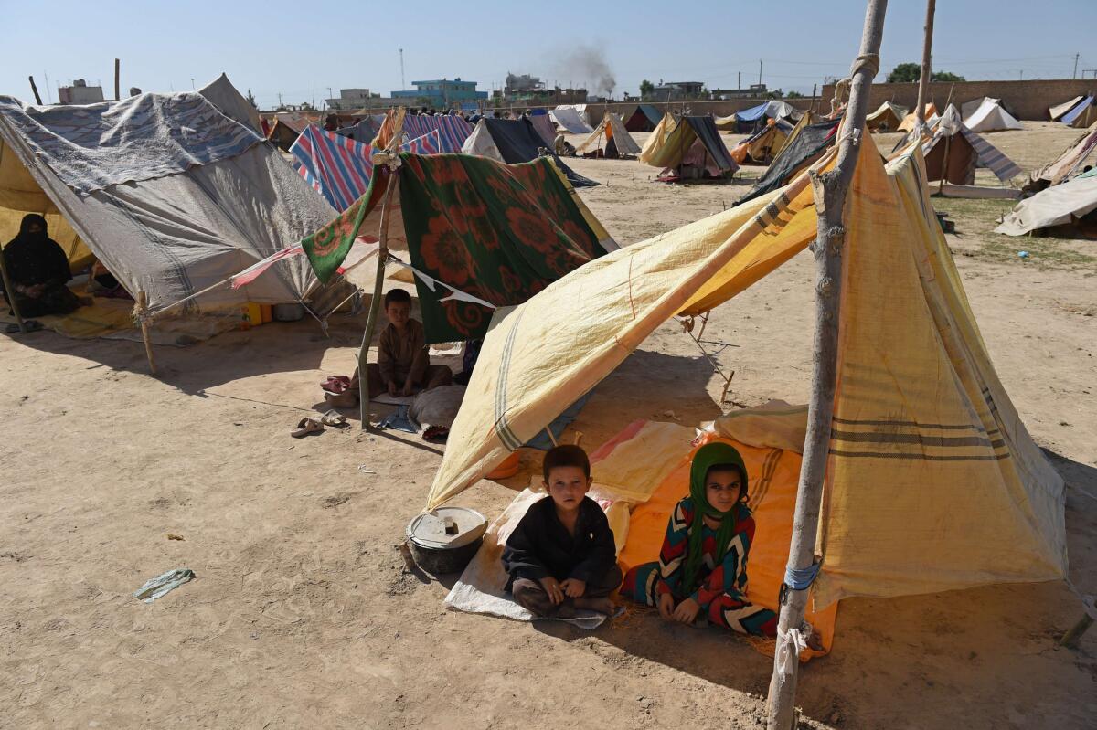 Afghan children displaced by fighting against Taliban militants sit in their tents at a makeshift camp in Kunduz, north of Kabul.
