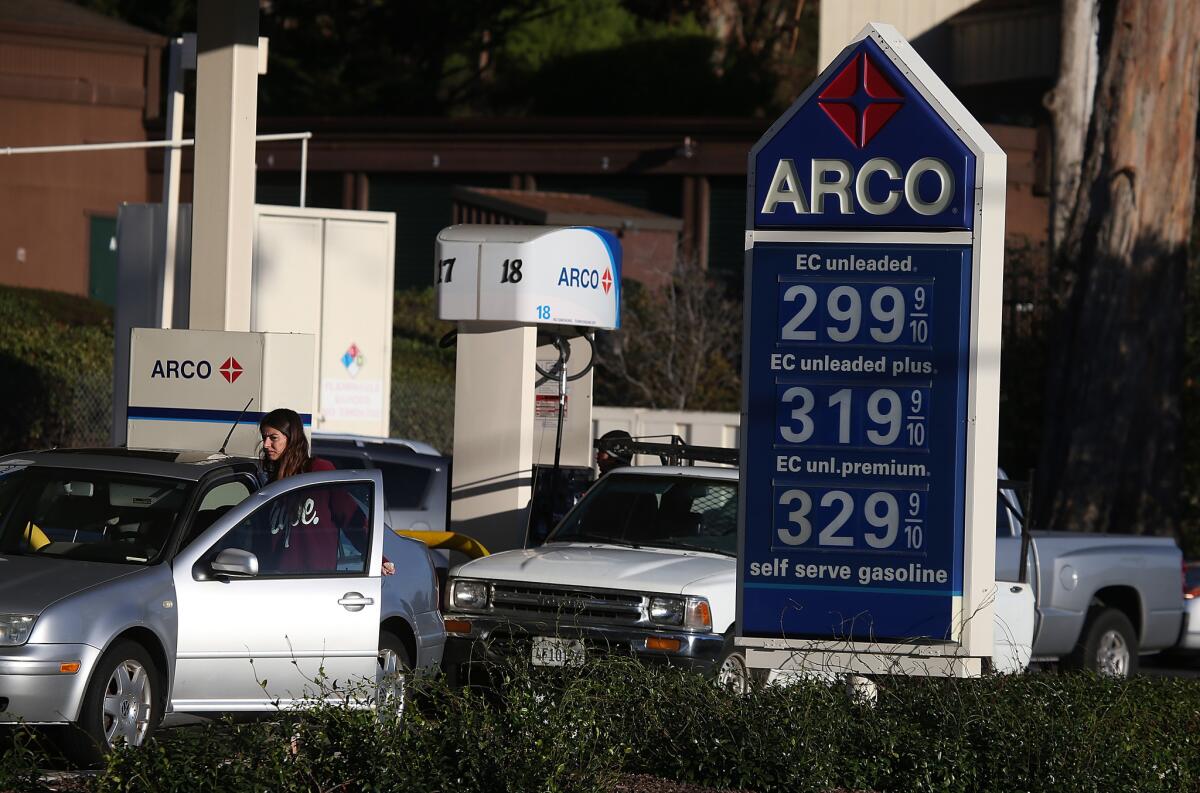 Gas prices are displayed at an Arco gas station on October 27 in Mill Valley. Gas prices have fallen to their lowest level in four years with the national average for a gallon of regular gasoline dropping to $3.08.