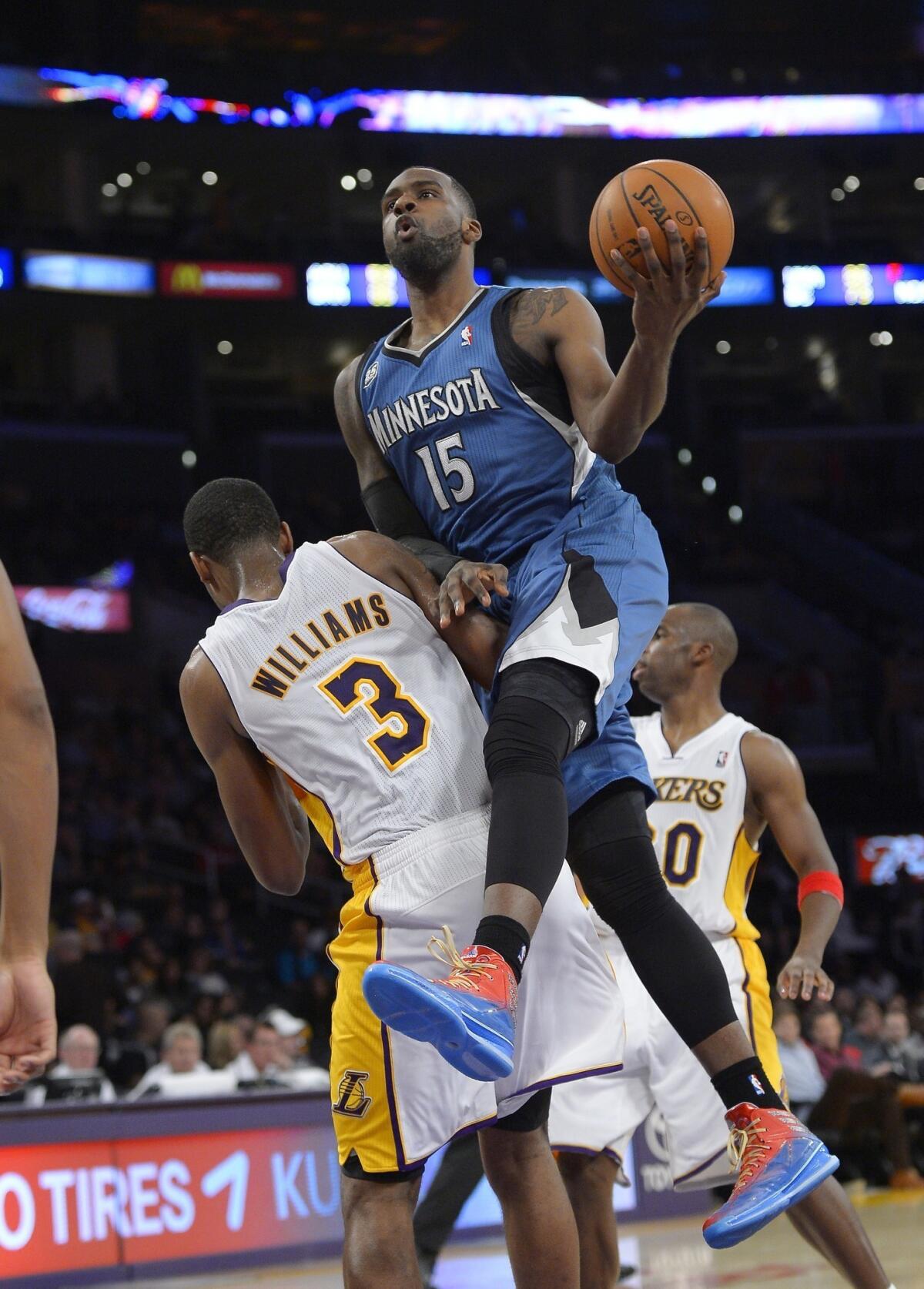 Minnesota Timberwolves rookie Shabazz Muhammad puts up a shot over Lakers forward Shawne Williams during a game on Nov. 10. Muhammad's off-court attire no longer includes a Jonas Brothers backpack.