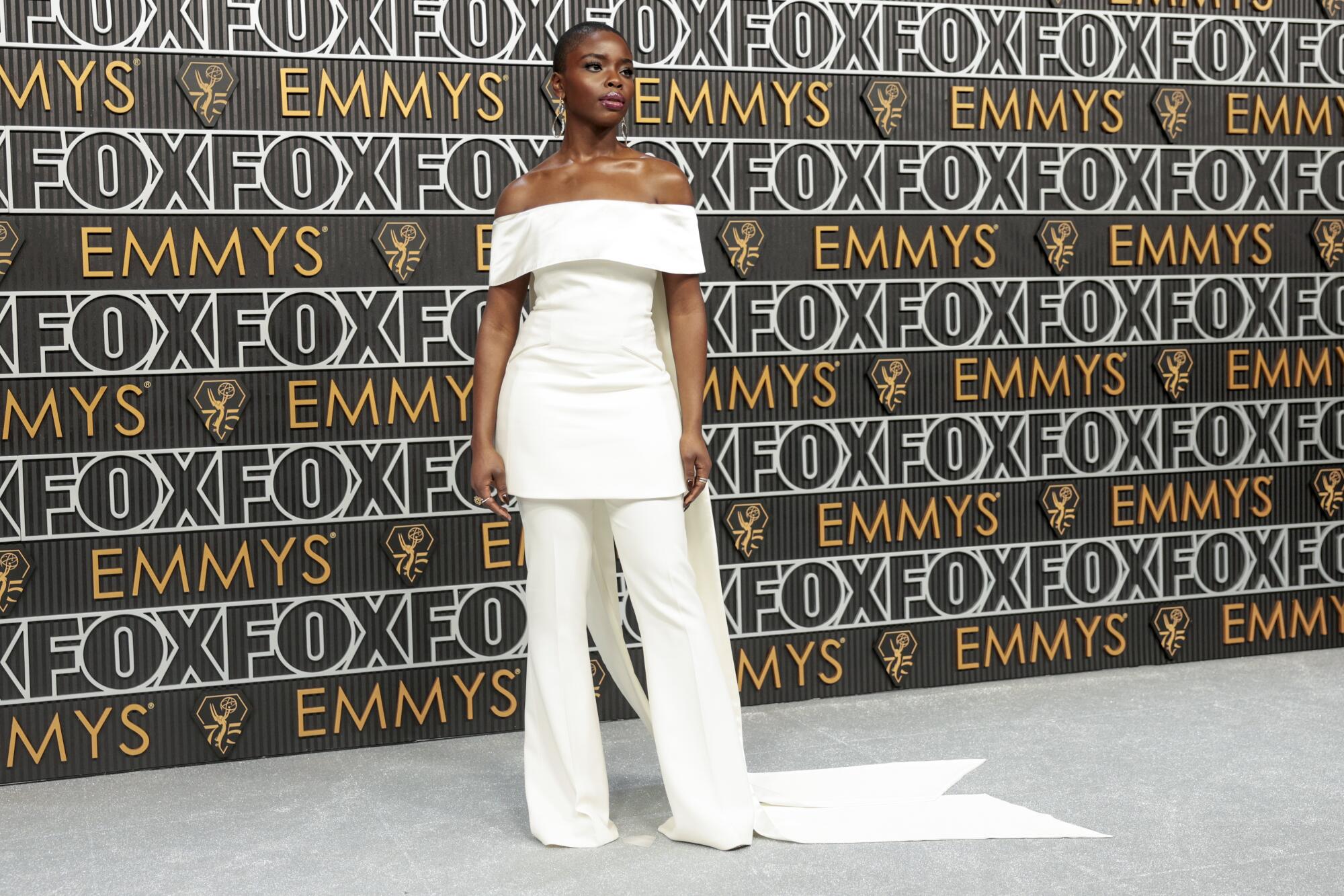Joy Sunday wears a white pantsuit on the Emmys red carpet. 