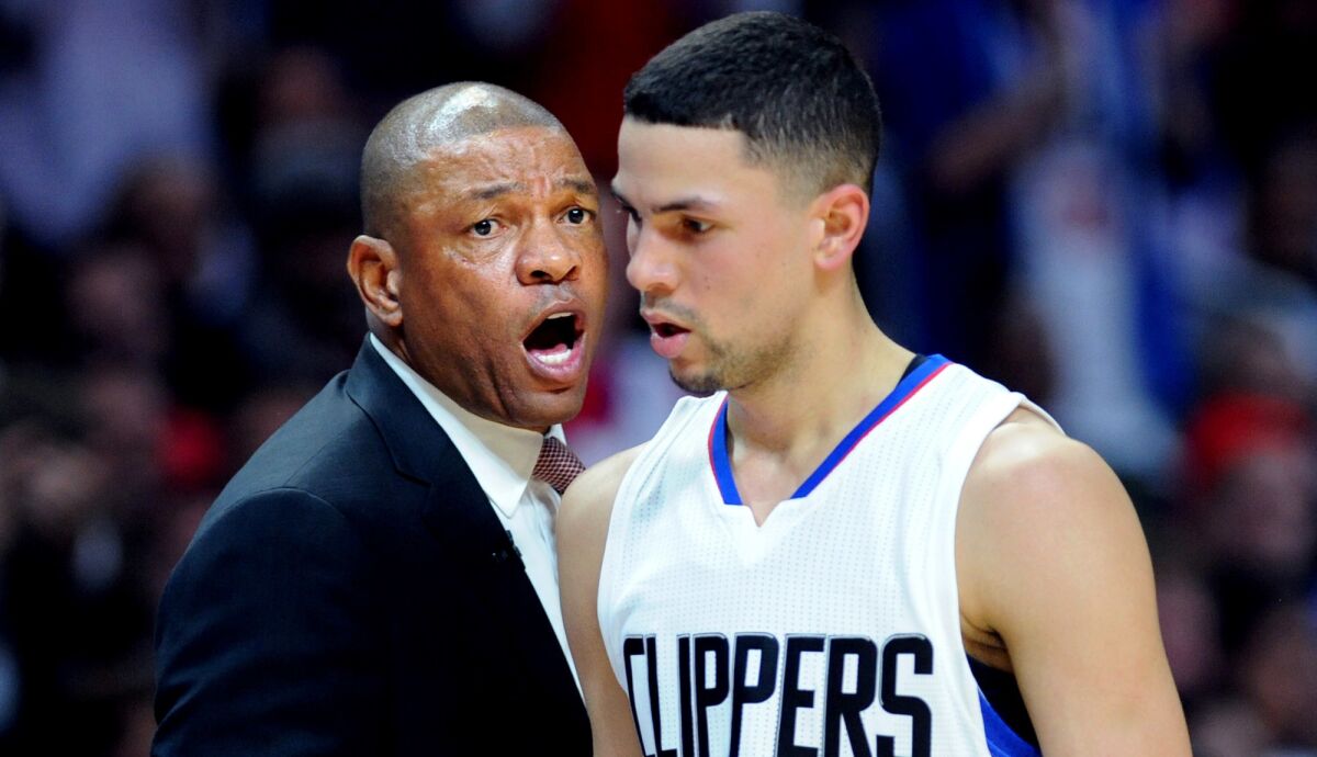 Coach Doc Rivers has a few words for son Austin during their days together with the Clippers.