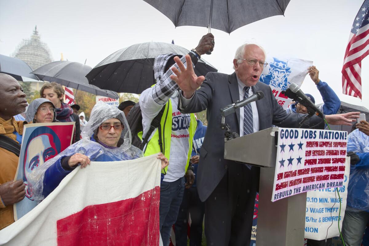 Democratic presidential candidate Bernie Sanders joins low-wage workers a Washington rally calling for a higher minimum wage.